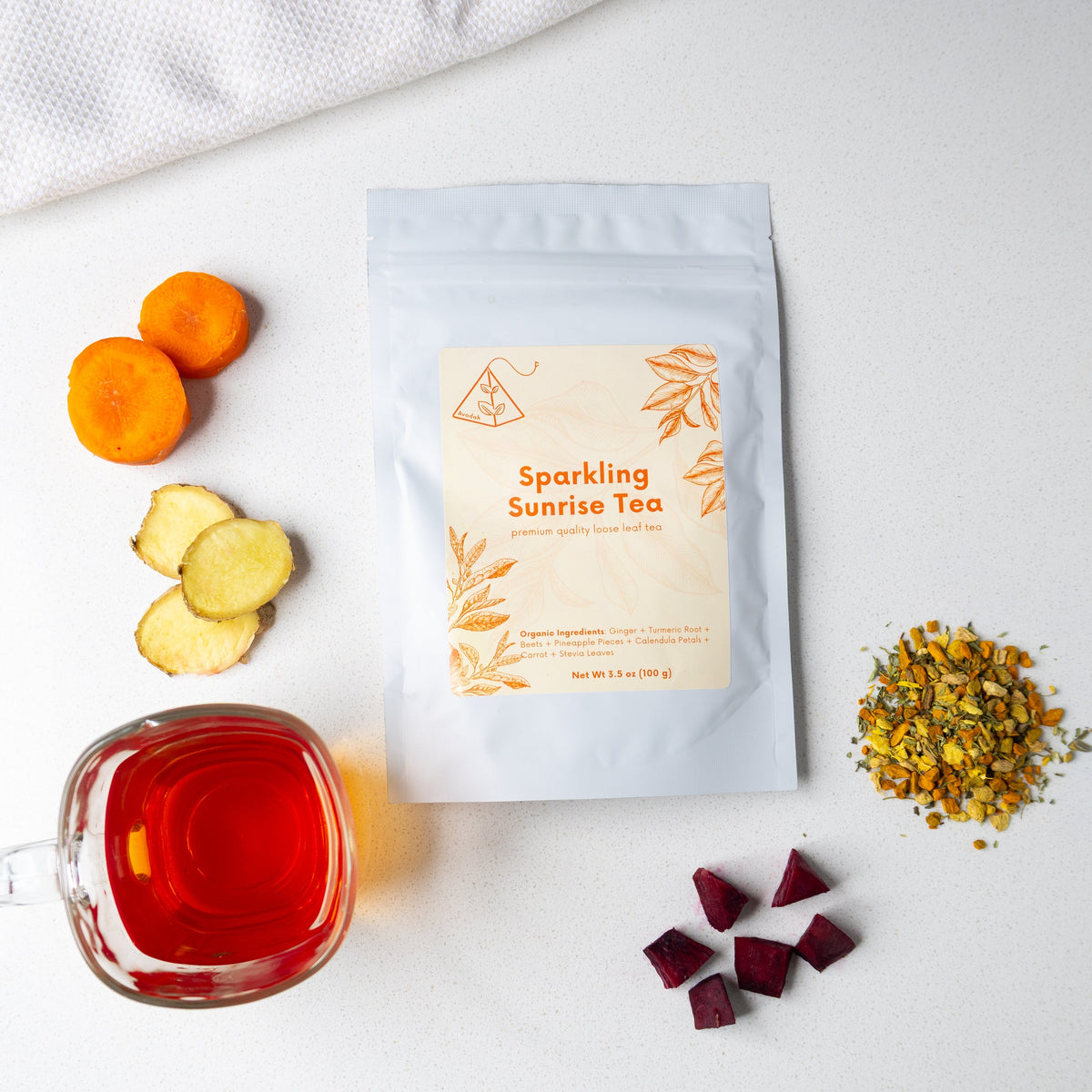 Sparkling Sunrise Tea organic blend with ginger, turmeric, carrot, beet, pineapple, and calendula for radiant skin glow